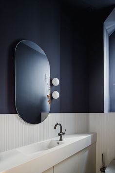 a bathroom with two sinks and a large mirror on the wall next to it's door