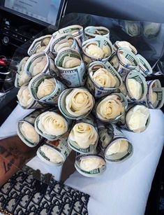 a bunch of rolled up money sitting on top of a desk next to a computer