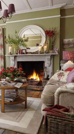 a living room filled with furniture and a fire place under a mirror on the wall