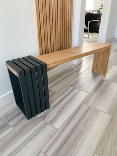 a wooden bench sitting on top of a tile floor