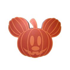 an orange mickey mouse pumpkin with a face drawn on it's head and ears