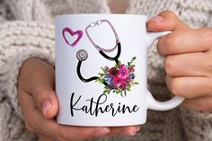 a person holding a coffee mug with a stethoscope and flowers on it