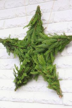 a green star hanging from the side of a brick wall