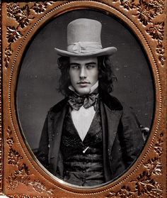 an old photo of a man wearing a top hat