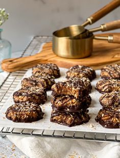 chocolate covered cookies sitting on top of a cooling rack