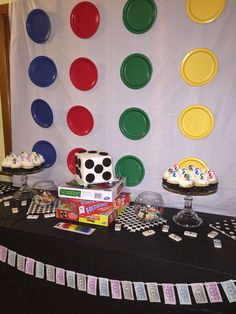 a black table topped with lots of cakes and cupcakes