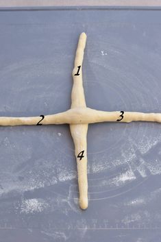 the cross is made out of dough and has numbers on each side to indicate where it came from