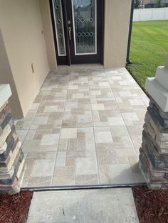 the front entrance to a home with stone steps