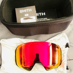 a pair of ski goggles sitting on top of a bag