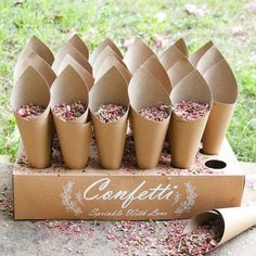 a bunch of cones that are on top of a cardboard box with confetti in them