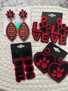 Red and black earrings perfect for Georgia Bulldog, animal lovers  Choose one from the variety : + acrylic bull dog earring + beaded heart with paw earring + beaded L-O-V-E with paw earring  + rhinestone football earring Trendy Red Beaded Earrings, Trendy Red Beaded Earrings As Gift, Trendy Red Beaded Earrings For Gift, Trendy Black Beaded Earrings For Gift, Uga Earrings, Football Earring, Rhinestone Football, Georgia Bulldog, Football Earrings