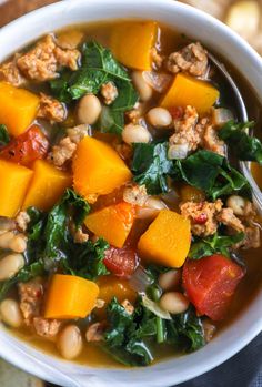 a white bowl filled with soup and vegetables