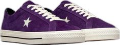 a pair of purple sneakers with white stars on them