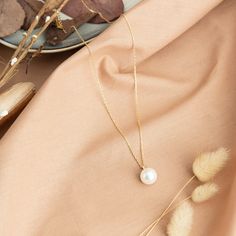 Our OCEAN single pearl necklace is designed to accompany you on your best days. It is made with a 14k solid gold chain from the highest quality crystal pearl. Perfect for wearing at your wedding or as a gift to bridesmaids. We make it a nice gift wrap for you. It fits perfectly with our other pearl jewelry. We can produce your necklace in special sizes you want. Do not hesitate to contact me for this. TECHNICAL INFORMATION 💎 Pendant  - Pearl Diameter ; 1 cm - Chain Length: 12-14-16-18  inches - Single Pearl Necklace Silver, Pearl Necklace Silver Chain, Pearl Gold Necklace, Gold Necklace Dainty, Dainty Pearl Necklace, Single Pearl Necklace, Design Box, Single Pearl, Fingerprint Jewelry