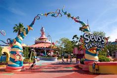 some people are walking around in front of the seussandner land theme park