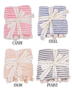 four different colors of towels tied together with ribbon and pom poms on each side