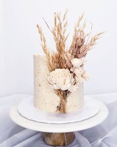 there is a cake with flowers on the top and frosting in the middle, sitting on a white plate