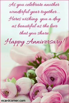 a bouquet of pink flowers sitting on top of a table next to a happy anniversary card