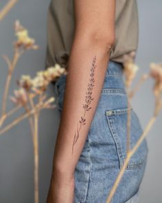 a woman's arm with a flower tattoo on the left side of her arm