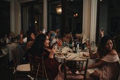 a group of people sitting around a dinner table