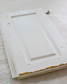 an old white cabinet door is being painted