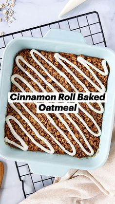 cinnamon roll baked oatmeal in a blue baking dish with white icing