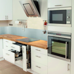 a kitchen with white cabinets and an oven