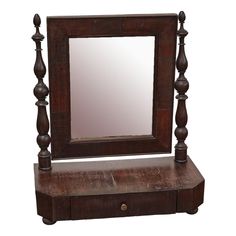 an old wooden dressing table with mirror on top