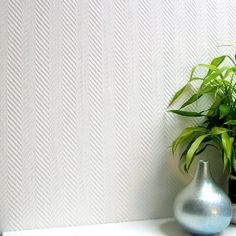 two vases are sitting on a shelf next to a wall with a plant in it