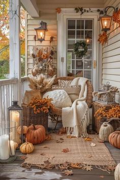 a porch decorated for fall with pumpkins and wicker furniture