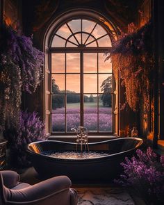 a bathtub sitting in front of a window next to a chair and flowers on the floor