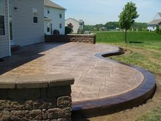 an outdoor patio with stone steps and retaining wall