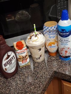 ice cream sundaes, milkshakes and other condiments sit on the kitchen counter