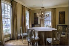 a dining room table with four chairs and a chandelier