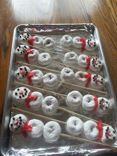 there are many donuts that have been made to look like snowmen on sticks