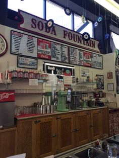 the inside of a restaurant with menus on the wall