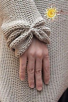 a woman's hand wrapped in a sweater