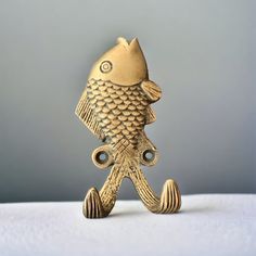 a gold fish figurine sitting on top of a table