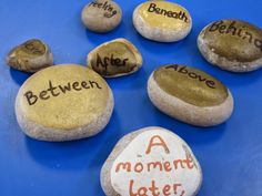 some rocks with writing on them sitting on a blue surface