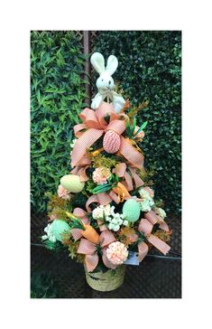 a basket filled with lots of different types of flowers and stuffed animals sitting on top of it