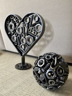 there are two sculptures made out of metal parts and one is shaped like a heart