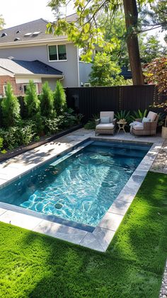 a small pool in the middle of a yard with grass around it and lawn furniture