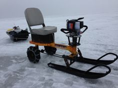 a small snowmobile is parked in the snow