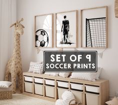 a set of 4 soccer prints on the wall next to a toy giraffe