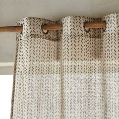 a close up view of a curtain with an arrow pattern on the top and bottom