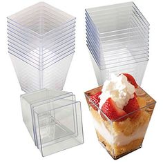 plastic containers with strawberries and whipped cream on top are stacked in the shape of hexagonal boxes