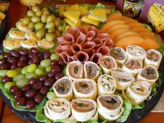 a platter filled with lots of different types of food on top of a table