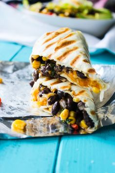 two quesadillas stacked on top of each other with black beans and corn