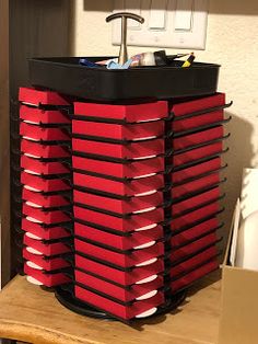 a stack of red boxes sitting on top of a wooden table