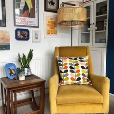 a chair and table in a room with pictures on the wall